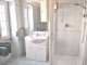 Upstairs bathroom with toilet, bidet, shower, basin and storage. 